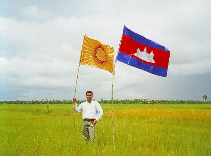 Flags.jpg - Maharishi Vedic University student marks the auspicious central point of Cambodia with the flag of the nation and the flag of organizations teaching the Transcendental Meditation programme throughout the world.