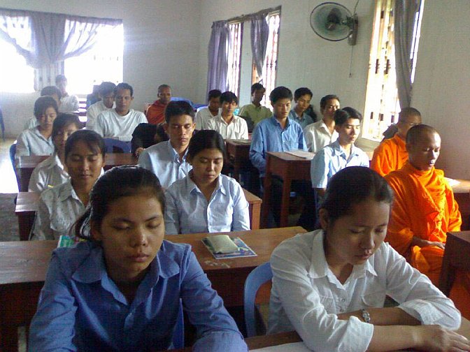 slide14.jpg - The school day at Maharishi Vedic University begins and ends with twenty minutes of Transcendental Meditation. The men in orange robes are among many thousands of Buddhist monks across Asia that added TM to their daily routine.