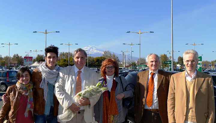 Italy-004.jpg - Dr Morris (holding flowers), President of Maharishi University of Management, USA, arrived to a warm welcome in Cantania, Italy, where he met with Dr Mariano. Next to Dr Morris is Giovana, a middle school teacher who has successfully introduced Transcendental Meditation into her school.
