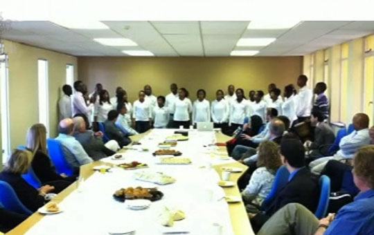MIIchoirMeeting.jpg - The Maharishi Institute choir sings at an executive breakfast for Johannesburg businessmen interested in learning about the school. Students enjoyed telling heart-warming stories about taking great leaps in their learning abilities and becoming accomplished, confident adults through Consciousness-Based Education.