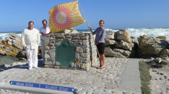 CapeAgulhas01.jpg - Dr Morris raised the Flag of Invincibility above this stone monument that represents the southern most tip of South Africa, where the Indian Ocean meets the Atlantic Ocean.
