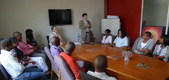 SouthAfrica208.jpg - Back in Johannesburg at the Maharishi Institute (MI), Dr Taddy Blecher (standing) conducted a successful press interview with students and a newspaper called ?New Age?. Dr Morris, seated at the head of the table listened.