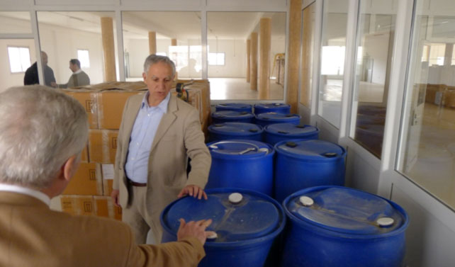 102s.jpg - During their tour of the warehouse, the group examines barrels filled with supplies for making perfumes and essential oils.
