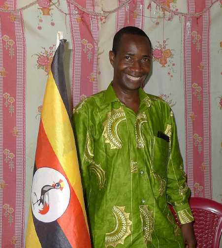 Uganda-GGn-(30).jpg - The EDAPO Director, Mark Mugabe, wants to make his community ?TM Town #2? after Fairfield, Iowa, USA! Here he is pictured next to the Uganda flag.