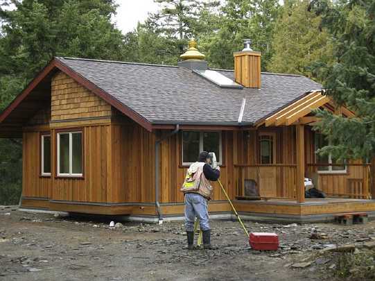 54.4.jpg - Salt Spring Island, BC, Canada: A vastu house in the final stages of completion. A surveyor is measuring for the deer fence to insure that it is perfectly oriented.